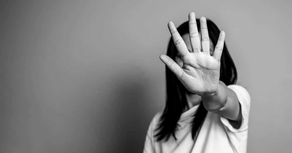 woman raised her hand for dissuade, campaign stop violence against women. asian woman raised her hand for dissuade with copy space, black and white color