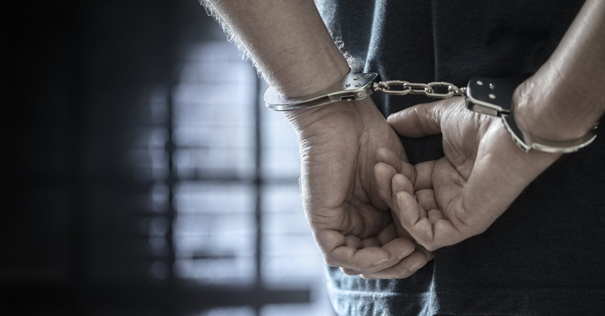 criminal wearing handcuffs in prison
